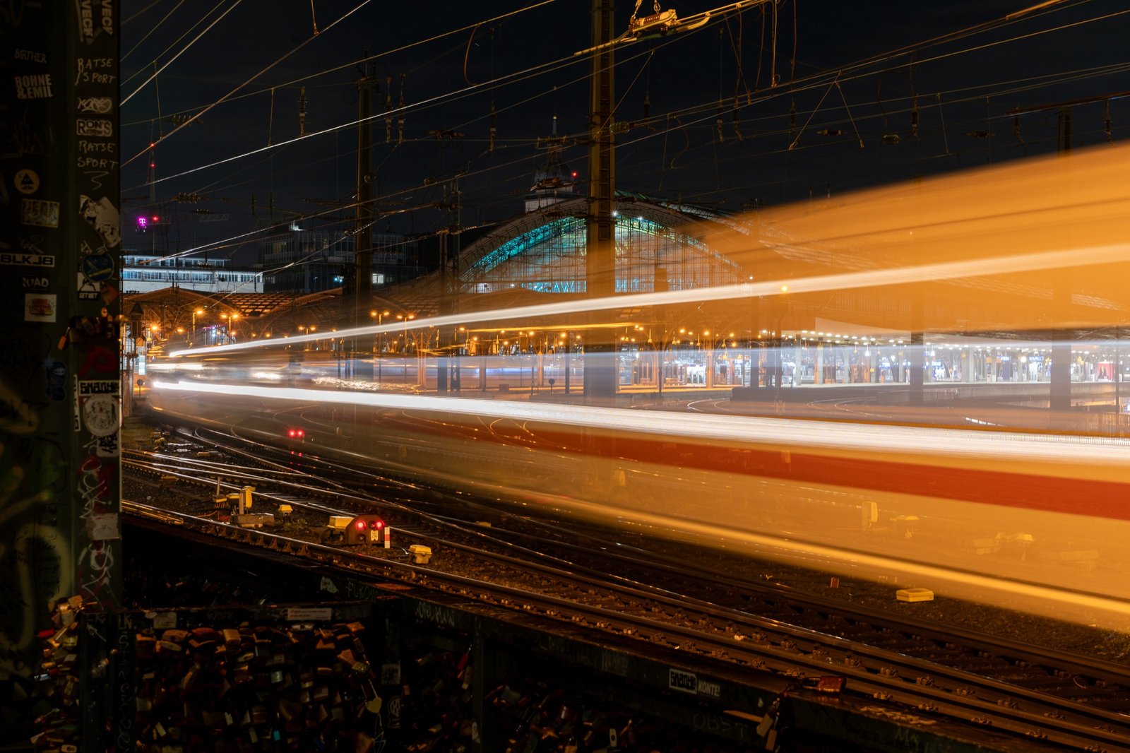 Long-exposure transit streaking through a night rail station