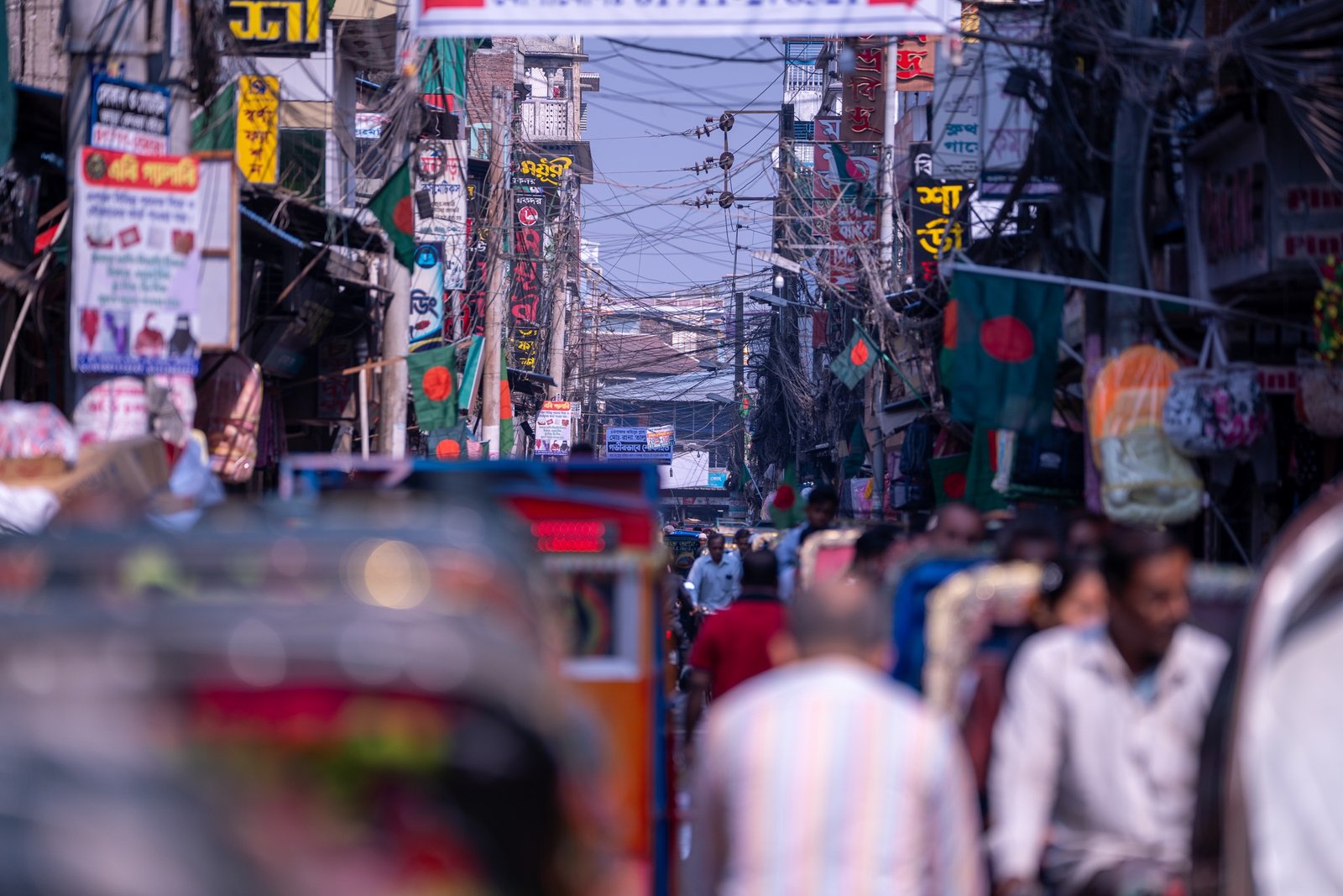 Street scene with Bangladesh flags and dense city signage