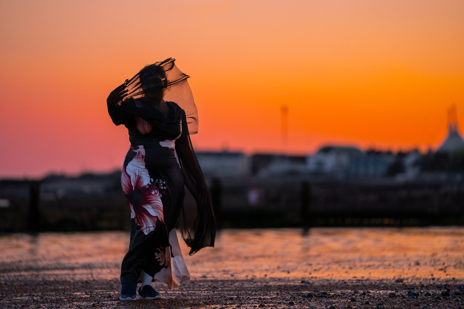Figure in silhouette against a vivid sunset sky